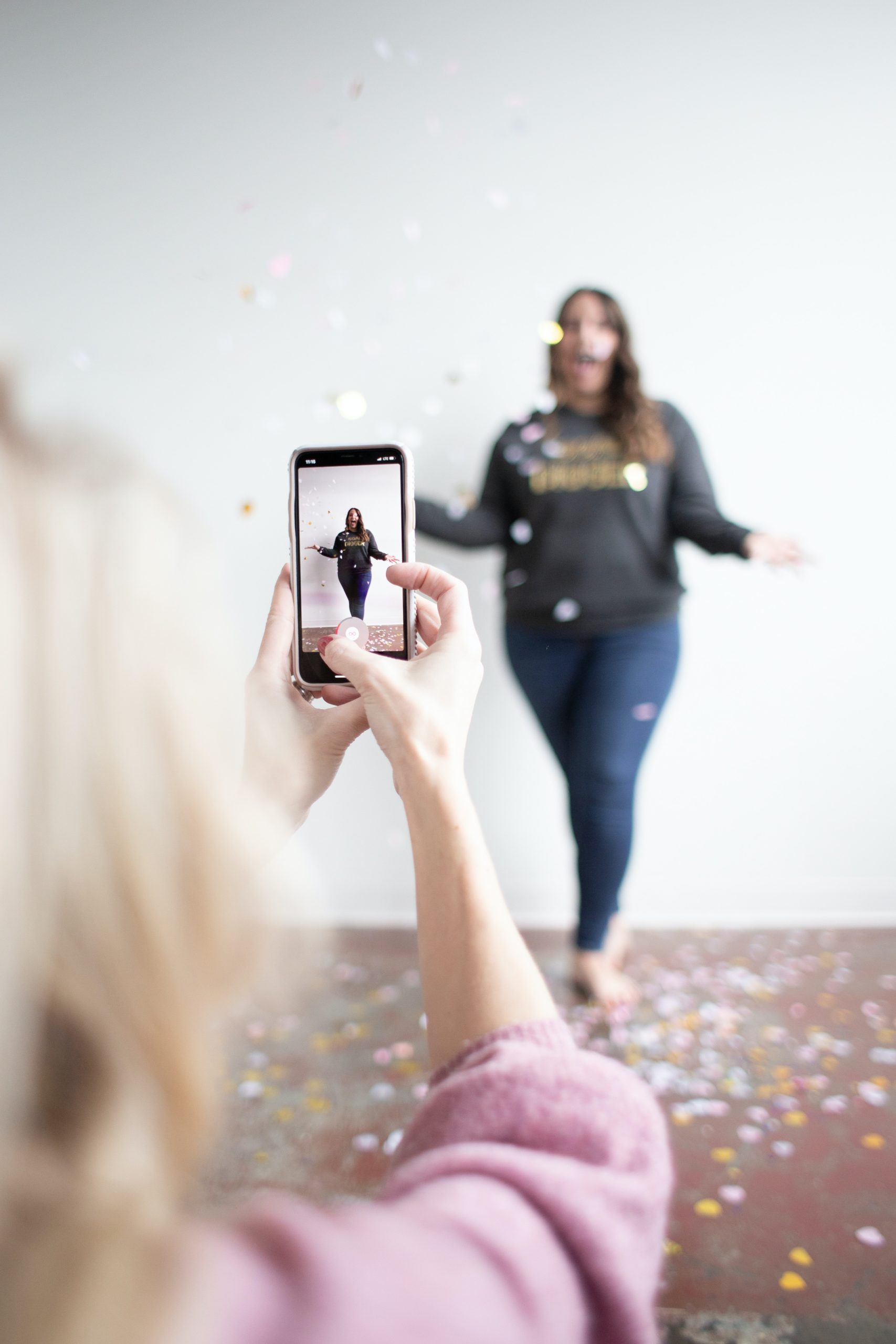 women with confetti having photograph taken