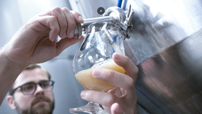 man pouring a beer