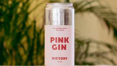 pink gin can in front of plants