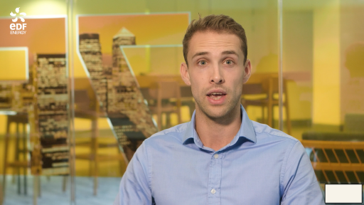 Man speaking in front of yellow screen